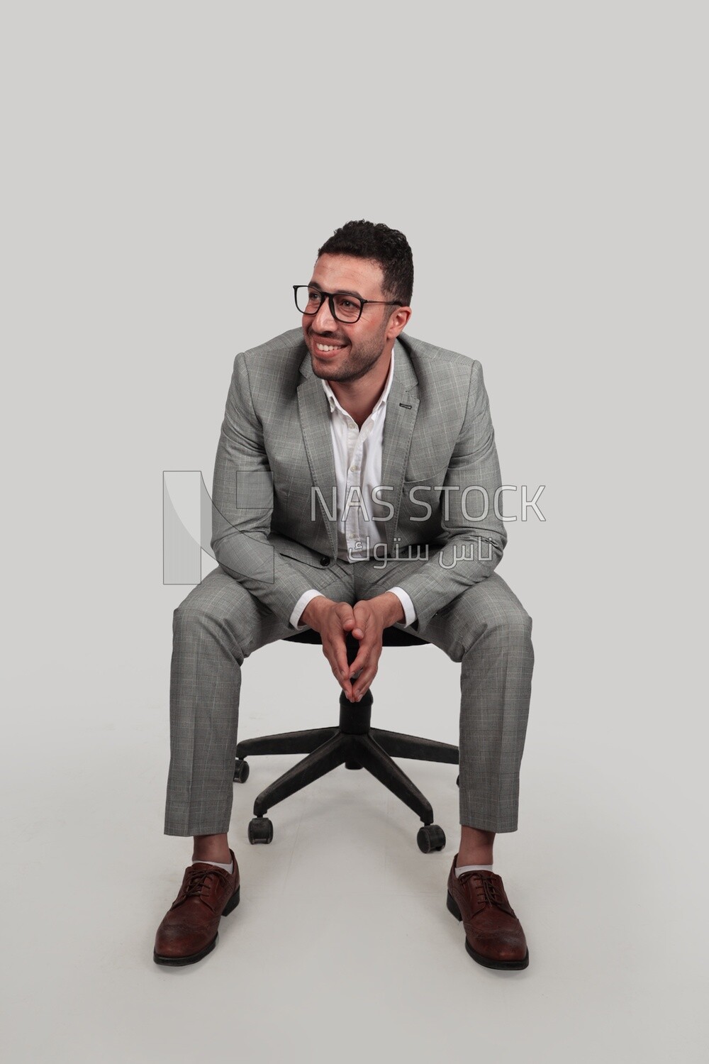 Photo of a businessman with formal wear sitting on a chair, business development and partnerships, business meeting, Model