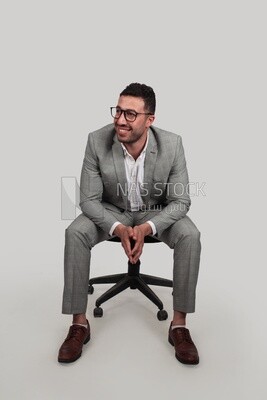 Photo of a businessman with formal wear sitting on a chair, business development and partnerships, business meeting, Model
