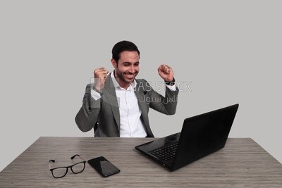Photo of a businessman with a formal suit sitting at a desk working on a laptop looking happy, business development and partnerships, business meeting, Model