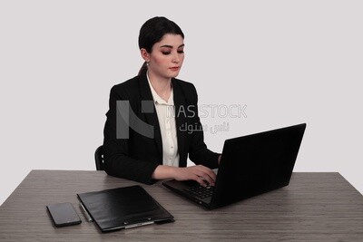 Photo of a businesswoman with a formal suit sitting at a desk working on a laptop, business development and partnerships, business meeting, Model