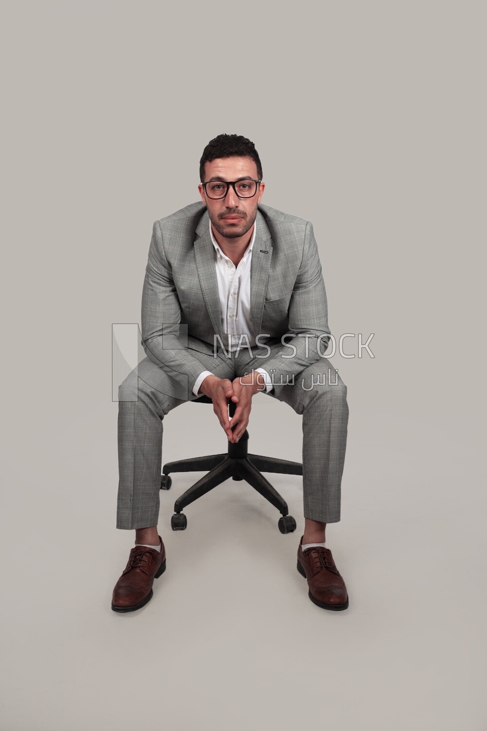 Photo of a businessman with formal wear sitting on a chair, business development and partnerships, business meeting, Model
