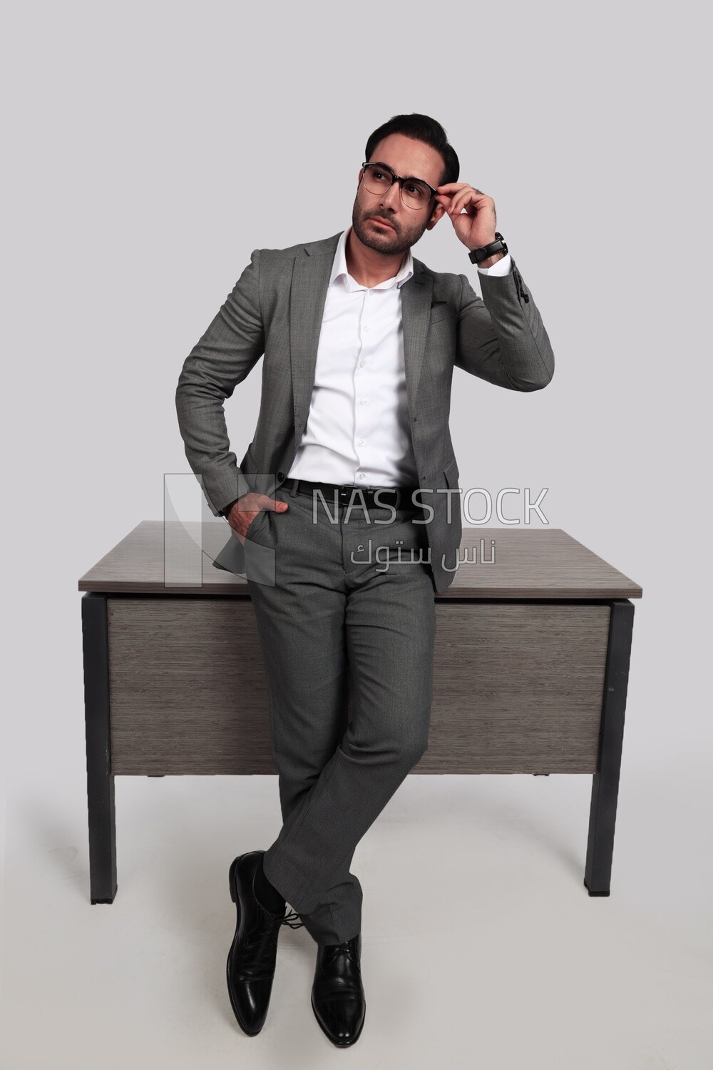 Photo of a businessman in a formal suit leaning on the office, business development and partnerships, business meeting, model