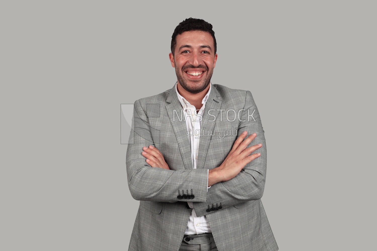 Photo of a businessman in a formal suit with crossed hands, business development and partnerships, business meeting, Model