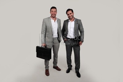 Photo of two men standing together, discussing work, business development and partnerships, business meeting, Model