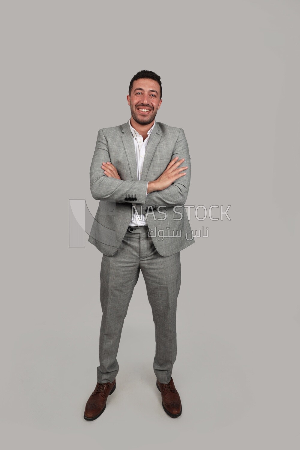 Photo of a businessman in a formal suit with crossed hands, business development and partnerships, business meeting, Model