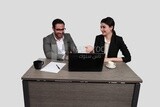 Photo of a businessman and a businesswoman sitting in the office discussing the work, business development and partnerships, business meeting, Model