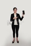 Photo of a businesswoman with a formal suit holding her mobile phone, business development and partnerships, business meeting, Model