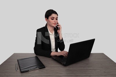 Photo of a businesswoman with a formal suit sitting at a desk working on a laptop, business development and partnerships, business meeting, Model