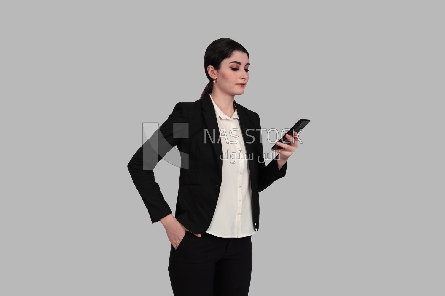 Photo of a businesswoman in formal wear standing and checking her mobile, business development and partnerships, business meeting, Model