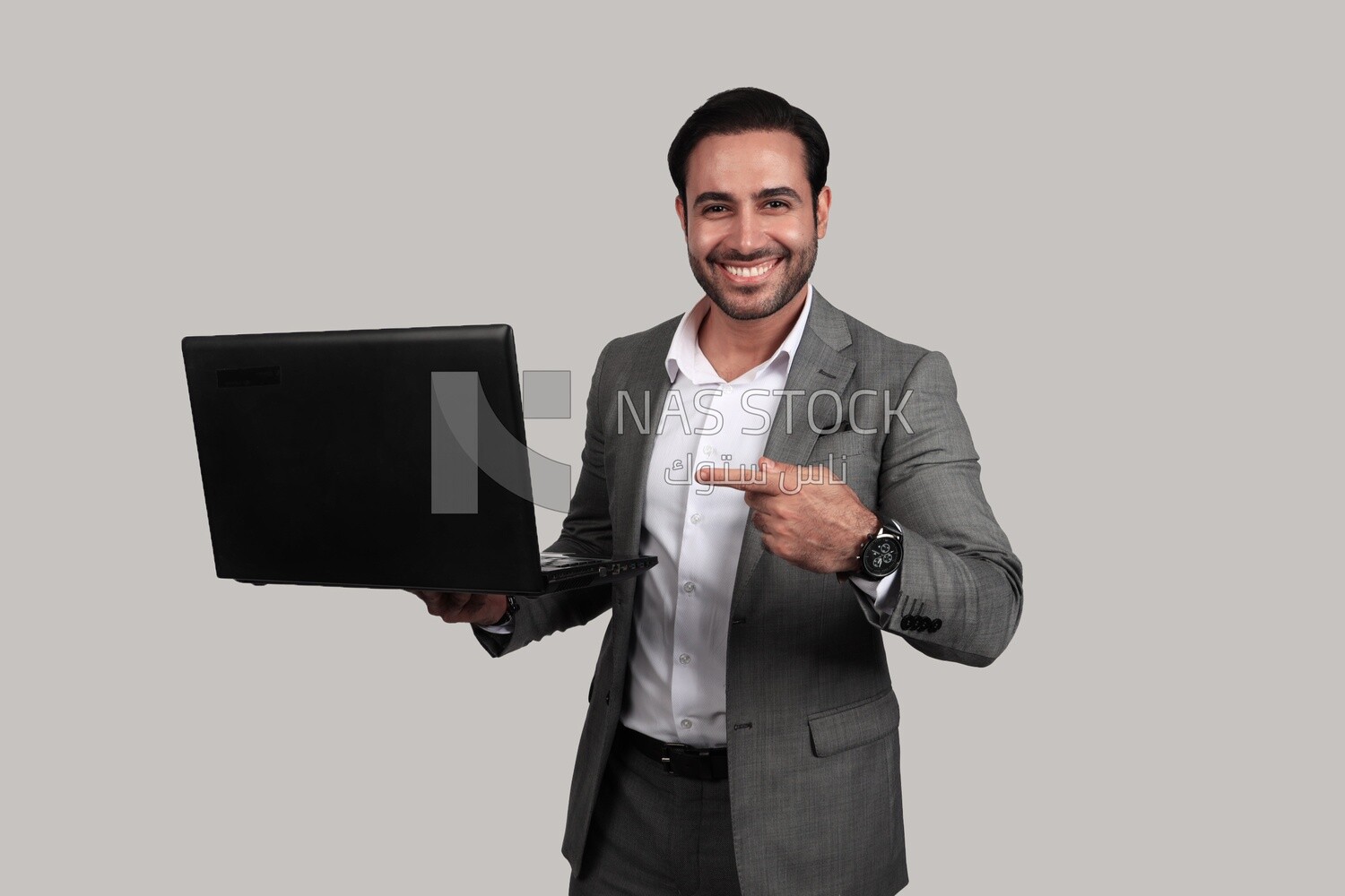 Photo of a businessman with a formal suit holding a laptop, business development and partnerships, business meeting, Model