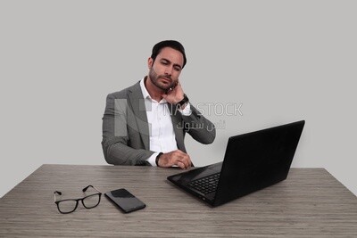 Photo of a businessman with a formal suit sitting at a desk working on a laptop, business development and partnerships, business meeting, Model
