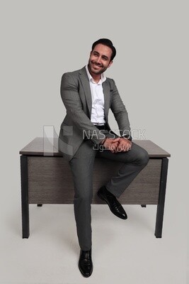 Photo of a businessman in a formal suit leaning on the office, business development and partnerships, business meeting, model