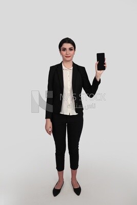 Photo of a businesswoman with a formal suit holding her mobile phone, business development and partnerships, business meeting, Model