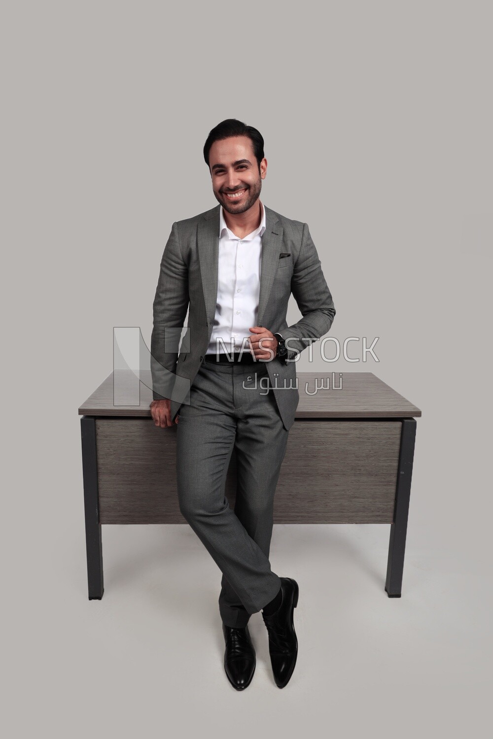 Photo of a businessman in a formal suit leaning on the office, business development and partnerships, business meeting, model