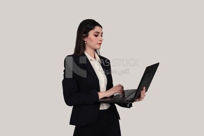 Photo of a businesswoman with a formal suit holding a laptop, business development and partnerships, business meeting, Model