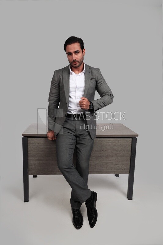 Photo of a businessman in a formal suit leaning on the office, business development and partnerships, business meeting, model