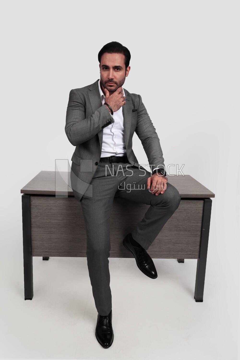 Photo of a businessman in a formal suit leaning on the office, business development and partnerships, business meeting, model