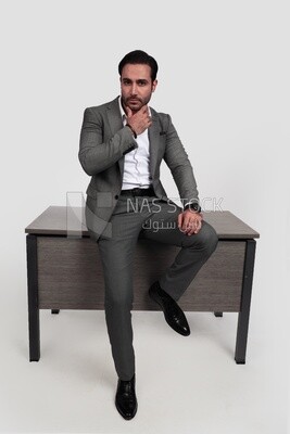 Photo of a businessman in a formal suit leaning on the office, business development and partnerships, business meeting, model