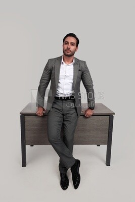 Photo of a businessman in a formal suit leaning on the office, business development and partnerships, business meeting, model
