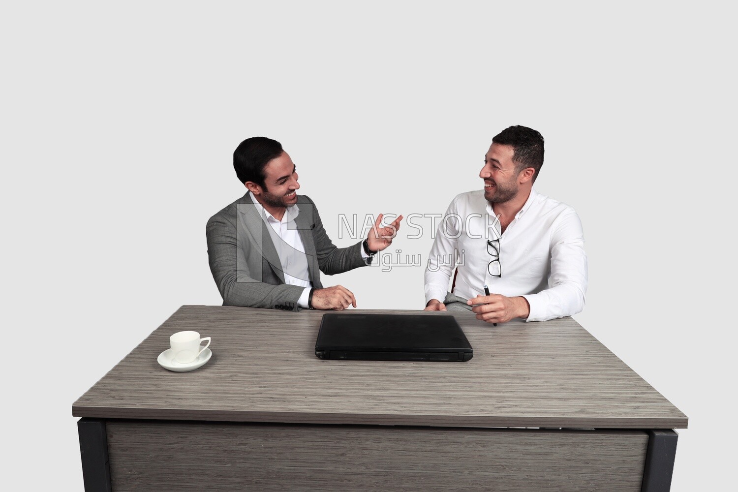 Photo of two men sitting in the office, discussing the work, business development and partnerships, business meeting, Model