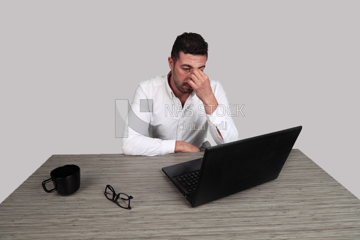 Photo of a businessman with a formal suit sitting at a desk working on a laptop, business development and partnerships, business meeting, Model