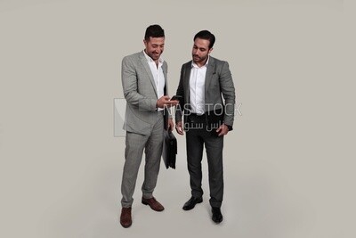 Photo of two men standing together, discussing work, business development and partnerships, business meeting, Model