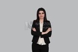 Photo of a businesswoman standing with crossed hands, meeting at the workplace, discussing work tasks