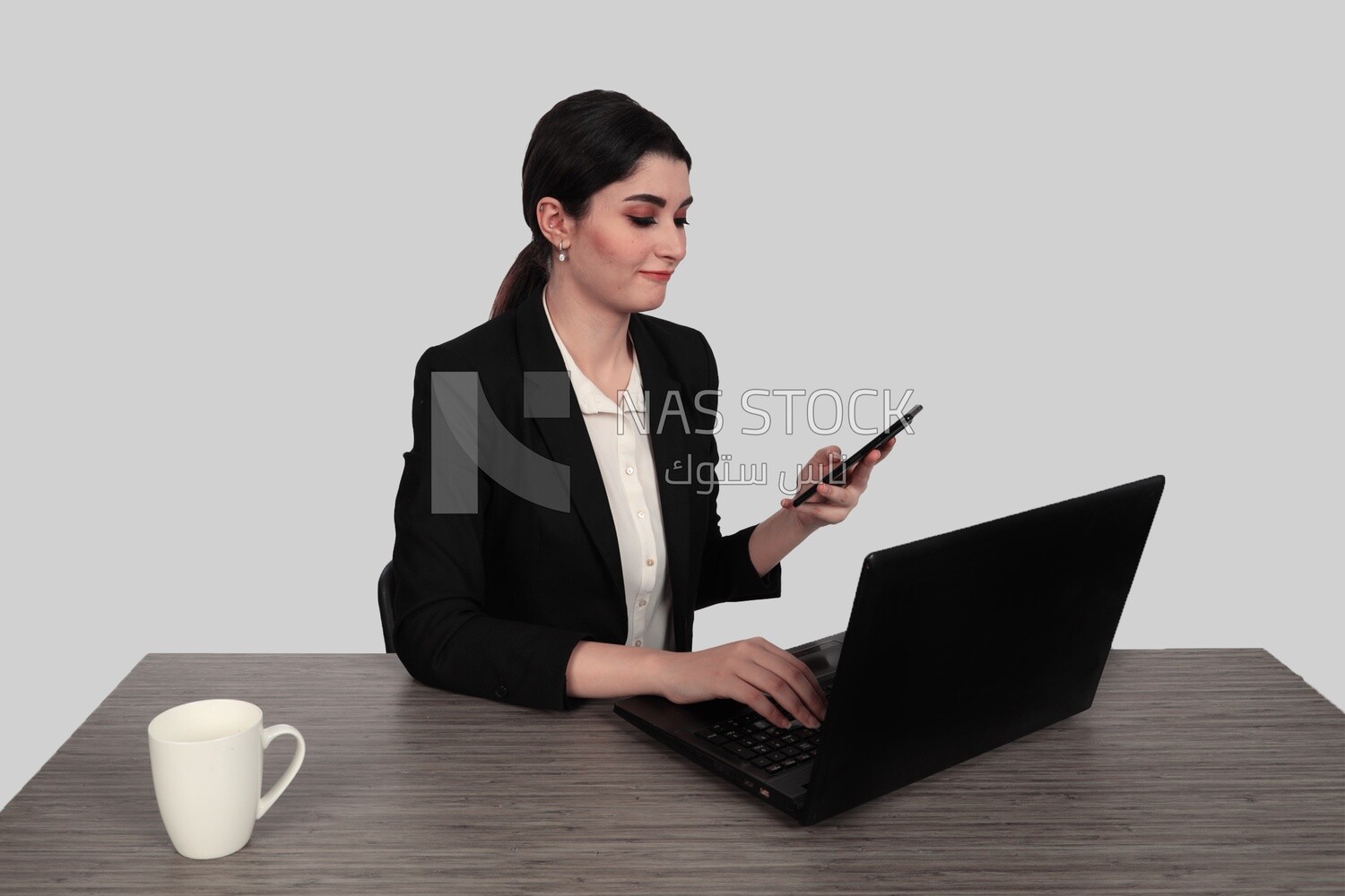 Photo of a businesswoman with a formal suit sitting at a desk working on a laptop, business development and partnerships, business meeting, Model
