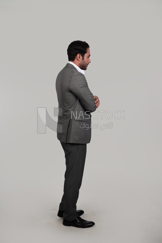 Side view for a photo of a businessman in a formal suit with crossed hands, business development and partnerships, business meeting, Model