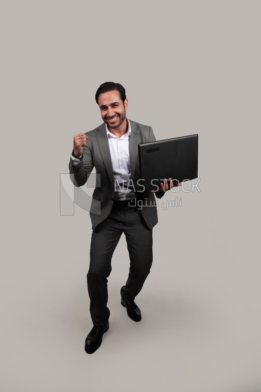 Businessman with a formal suit holding a laptop, business development and partnerships, business meeting, Model