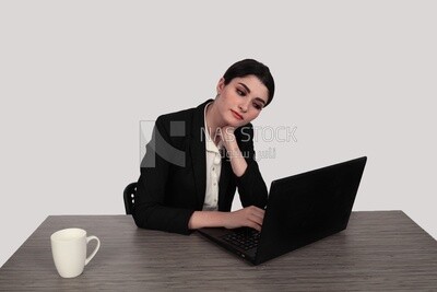 Photo of a businesswoman with a formal suit sitting at a desk working on a laptop, business development and partnerships, business meeting, Model