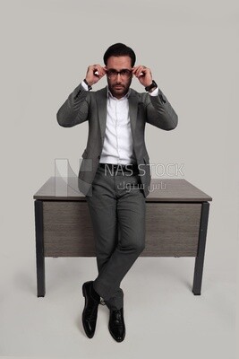 Photo of a businessman in a formal suit leaning on the office, business development and partnerships, business meeting, model