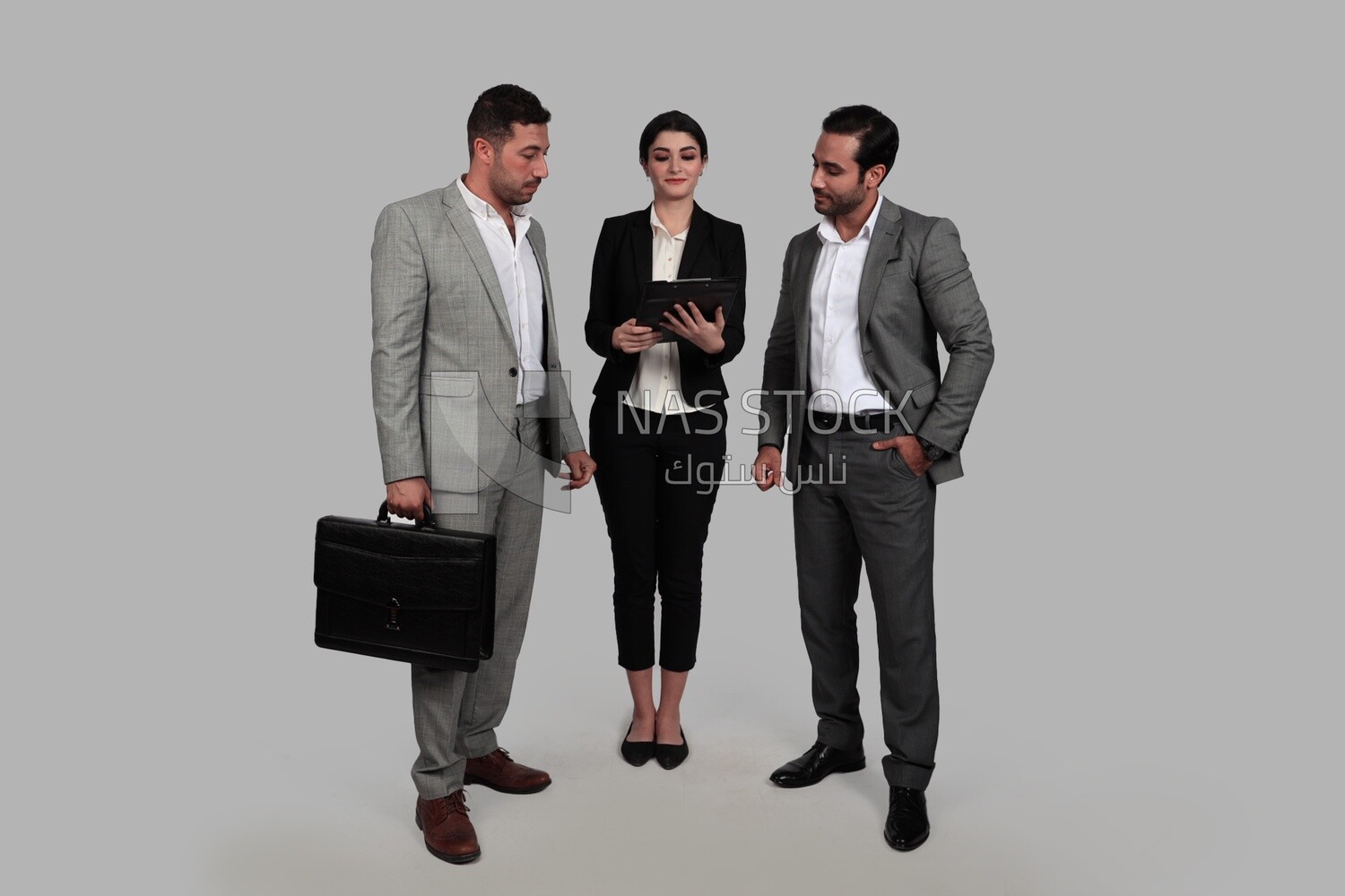 Photo of a businesswoman and two businessmen standing together checking work, business development and partnerships, business meeting, Model