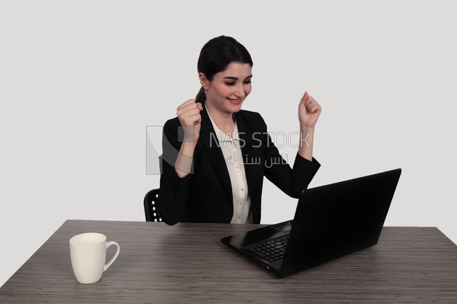 Photo of a businessman with a formal suit sitting at a desk working on a laptop looking happy, business development and partnerships, business meeting, Model