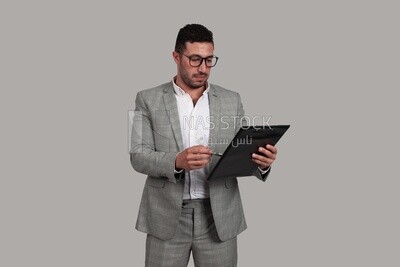 Photo of a businessman in a business suit checking documents, business development and partnerships, business meetings, models