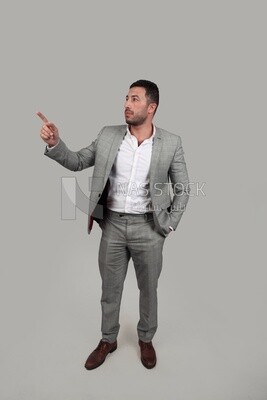 Photo of a businessman in formal wear standing pointing away, business development and partnerships, business meeting, Model