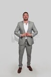 Photo of a businessman with a formal suit holding his hand on the suit button, business development and partnerships, business meeting, Model