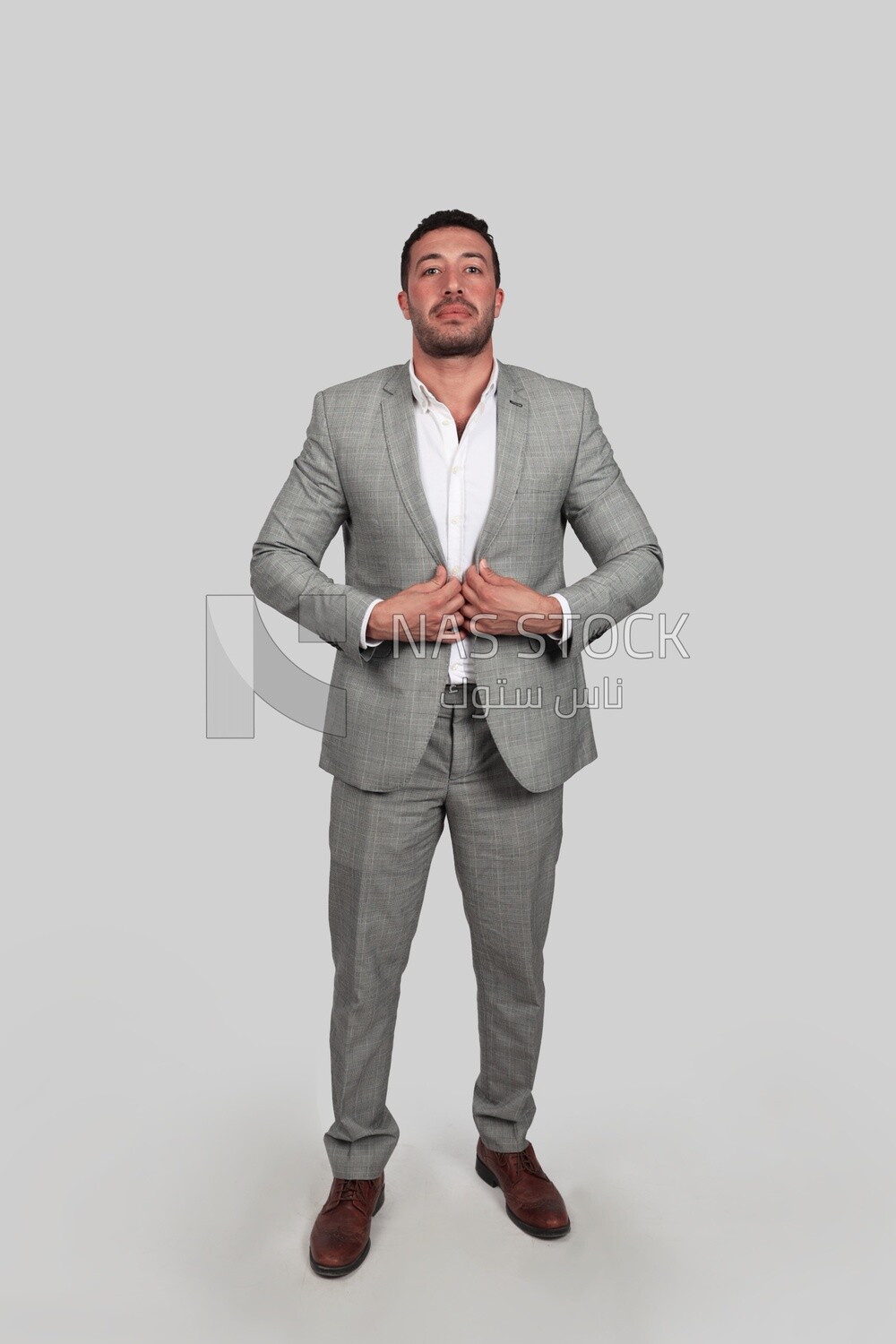 Photo of a businessman with a formal suit holding his hand on the suit button, business development and partnerships, business meeting, Model