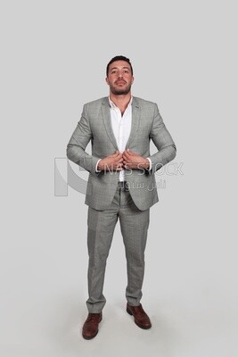 Photo of a businessman with a formal suit holding his hand on the suit button, business development and partnerships, business meeting, Model