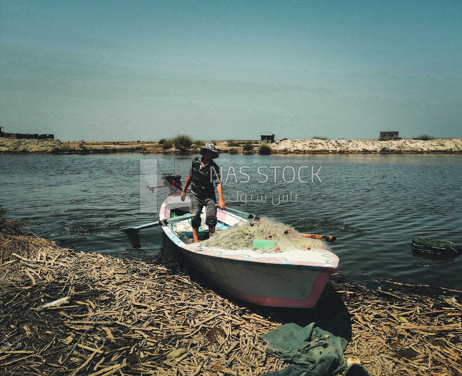 Man standing in a boat on the river, fishing, rural life, farm trees, and green plants, farm fields, trees and crops, farmland, a scenic landscape