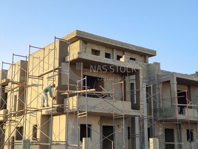 Worker who finishes the facade of the buildings