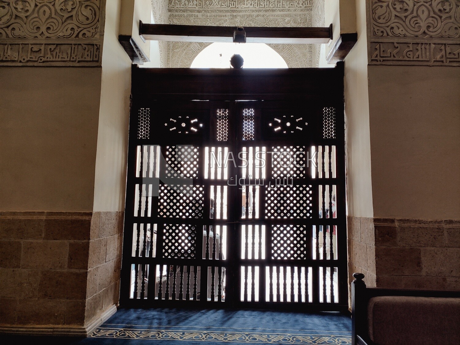 Wooden barrier separates the place of prayer from the square in the mosque