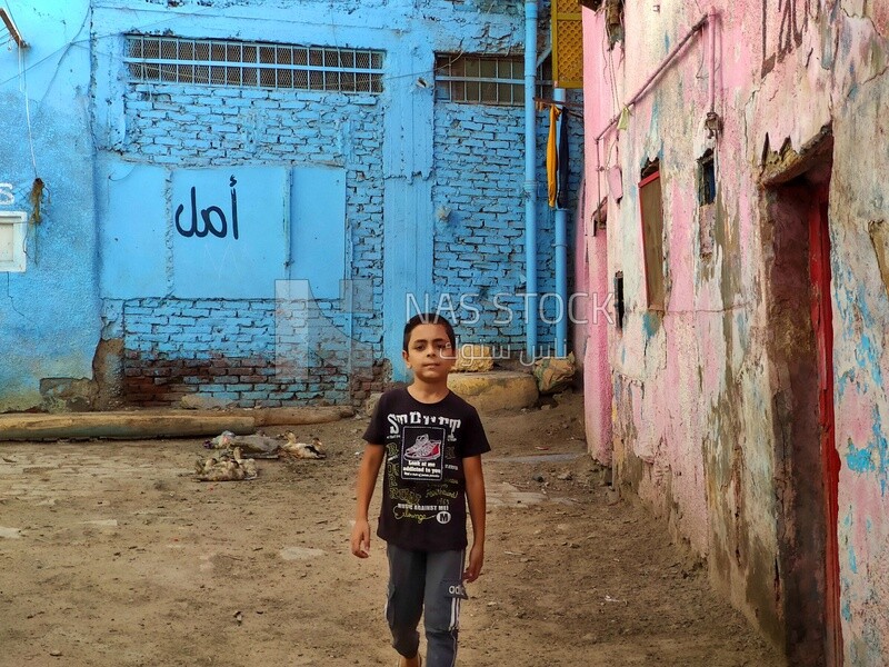 Young boy walks down the street in Egypt