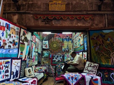 Egyptian craftsman sitting in a shop, tent market, Egyptian folk art, Khayamiya