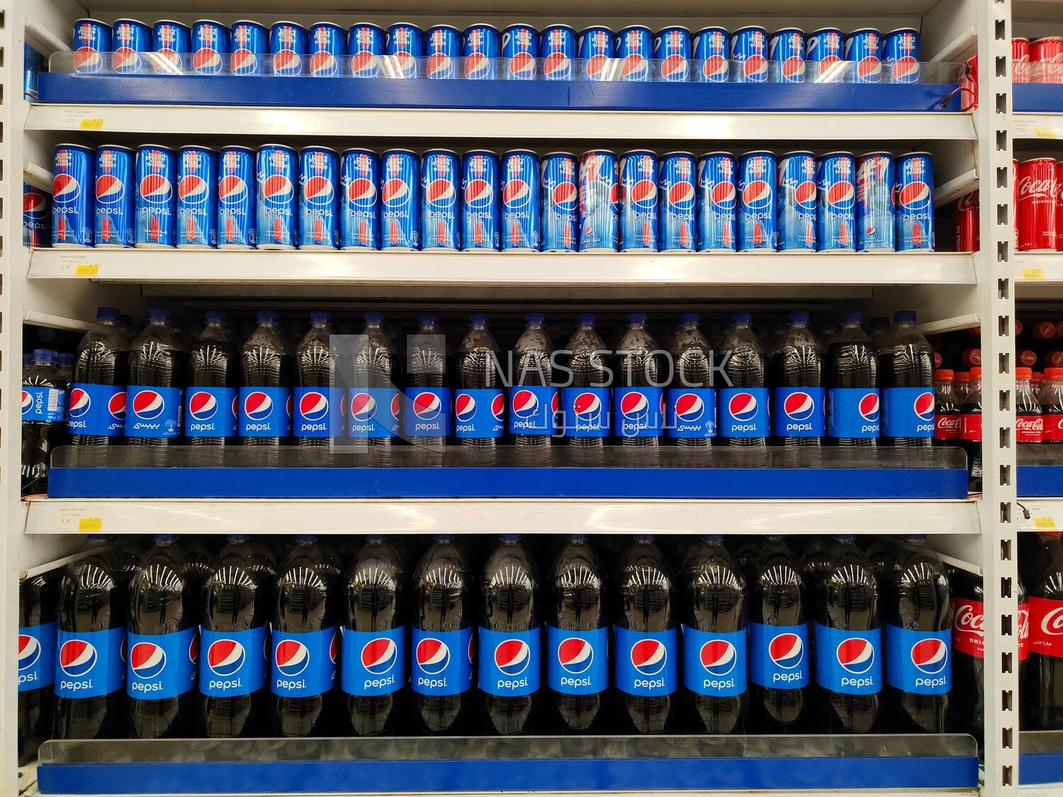 Shelves stacked with types of pepsi bottels