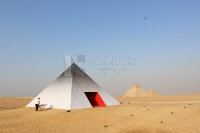 Model pyramid in the historical style next to the pyramids of Giza from the event of the &quot;Forever is now&quot; project