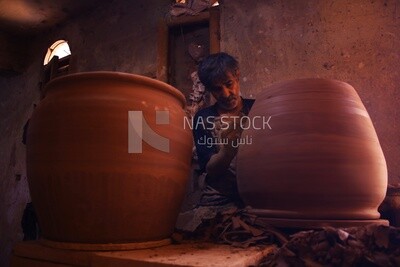Craftsman forming pottery pots inside a pottery workshop in Egypt