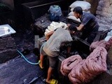 Yarn dyeing craftsmen working in an old dyeing workshop