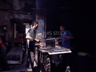 Two men working in a dyeing workshop