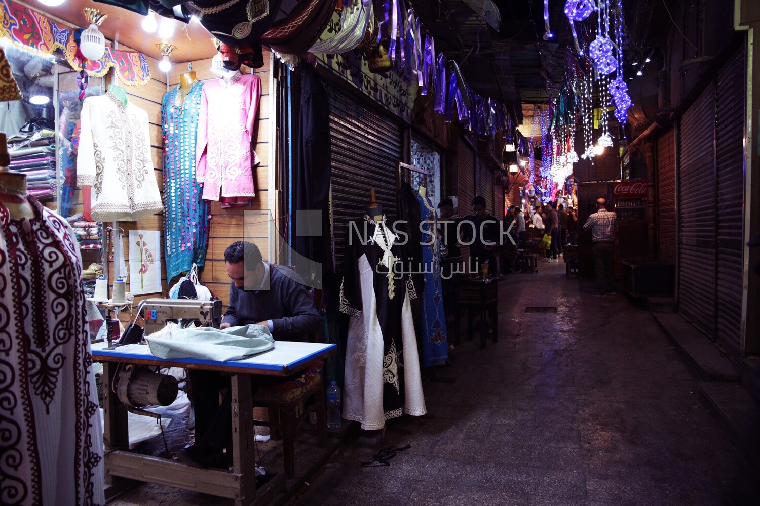 Man working in the profession of sewing, a sewing shop, the skill of sewing and mastering the tailoring of youthful clothes